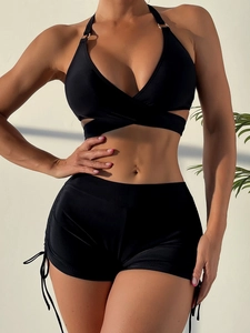 Detail of black halter bikini with gold ring hardware and drawstring boyshort bottoms