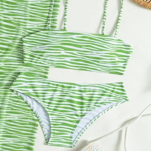 Detailed flat lay of green zebra print 3-piece bikini set with matching mesh sarong