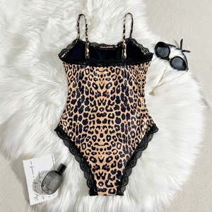 Sexy leopard print bodysuit for women featuring black lace trim on plush background