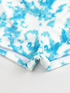 Blue and white tie-dye high-waist bikini bottoms with ribbed texture and reinforced hem