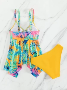 Detailed flat lay of tropical palm print tankini top with high-waisted yellow bikini bottom