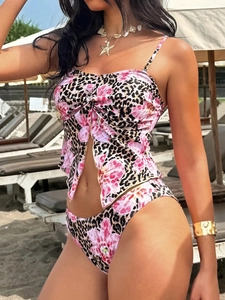 Detail of pink floral and leopard bikini with front knot and cutout on beach