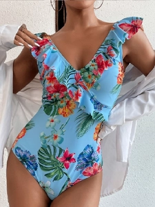 Detailed close-up of tropical floral print swimsuit with elegant ruffle V-neckline