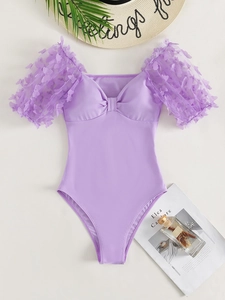 Detail of lavender one-piece swimsuit with 3D butterfly appliques and puff mesh sleeves