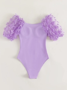 Detail of lilac bodysuit featuring sheer mesh sleeves and 3D butterfly floral appliques