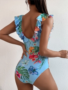 Detail of one-piece floral swimsuit featuring ruffled straps and deep V-back design
