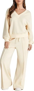 Detailed texture of cream knitted V-neck sweatshirt and matching drawstring trousers