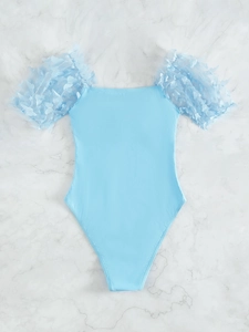 Detail of light blue one-piece swimsuit with mesh puff sleeves and 3D butterfly decor