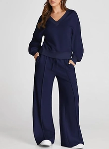 Detail of navy blue V-neck sweatshirt and matching high-waisted wide-leg lounge pants