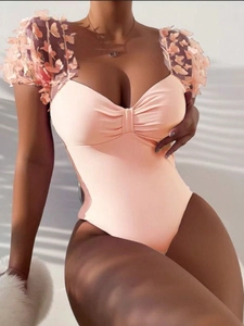 Detail of pink one-piece swimsuit featuring 3D butterfly appliques and sweetheart neckline
