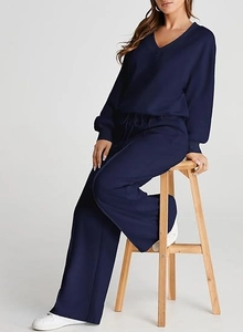Detailed close-up showing the soft knit texture and V-neckline of the navy blue casual set