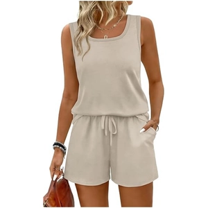 Detailed view of the drawstring elastic waistband and side pockets on beige casual shorts