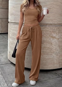 Detail of ribbed knit V-neck top and drawstring wide-leg pants in caramel brown color