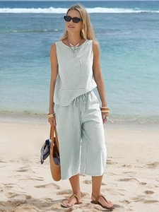 Detail view of women's striped sleeveless top and wide leg pants set for beach vacation