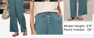 Detail of high waisted teal wide leg pants with drawstring waist and white buttons