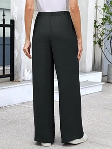 Rear view of high-waist wide-leg trousers in black textured fabric with elastic waistband