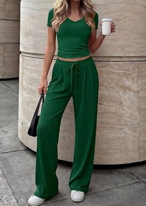 Detail of dark green two-piece lounge set showing ribbed texture and drawstring waist
