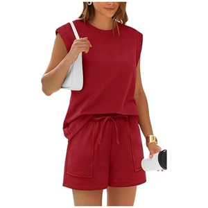 Detail view of burgundy sleeveless top and drawstring shorts with large functional pockets