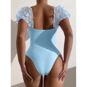 Light blue one-piece swimsuit with mesh butterfly appliqué and low back design