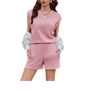 Detailed texture of pink ribbed knit two-piece set featuring sleeveless top and shorts