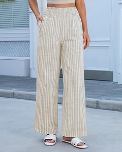 Detail of high waisted striped wide leg pants with smocked waistband and side pockets