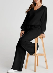 Detail of minimalist black V-neck knit lounge set with high waist wide leg pants