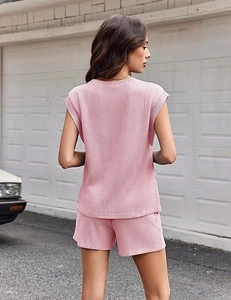 Back view of a casual pink ribbed knit short set with short sleeves and pocket details