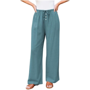 Detail of high waist teal wide leg pants featuring drawstring and decorative buttons