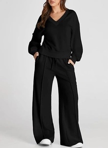Detail showing the vertical center seam and drawstring waist on black wide-leg trousers