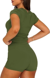 Detail of olive green ribbed knit crop top and high-waisted shorts set on model