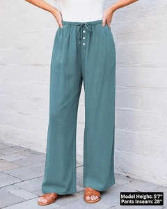 Detail of high waist linen wide leg pants with drawstring waist and white buttons