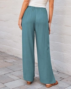 Rear view of teal high-waisted wide-leg trousers with elastic waistband and linen texture