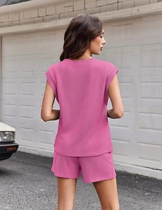 Close-up of rose red ribbed knit texture on a casual two-piece summer shorts set