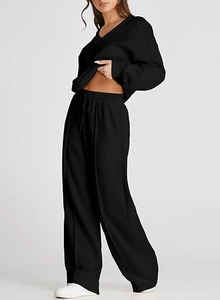 Detail of black V-neck sweatshirt and drawstring wide-leg pants set for women