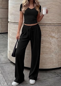 Detail of black V-neck short sleeve top and high-waist drawstring wide-leg pants set