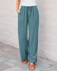 Detail view of high waist wide leg pants featuring drawstring belt and white buttons