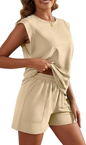 Detail of beige sleeveless top and shorts with side pockets and elastic drawstring waist