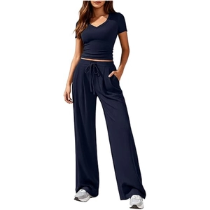 Detail of navy blue V-neck top and matching wide-leg trousers with drawstring waist