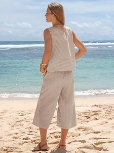 Detail of striped sleeveless top and wide-leg pants on beach for summer holiday