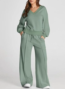 Detail view of sage green lounge set showing the V-neck sweater and stitched wide-leg pants