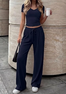 Detail of navy blue two-piece set featuring V-neck crop top and drawstring wide-leg pants