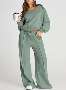 Detail view of sage green V-neck sweatshirt and wide-leg pants two-piece lounge set