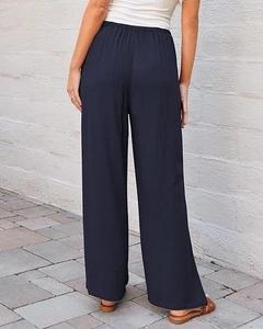 Rear view of high waist navy blue wide leg pants with elastic drawstring waist detail