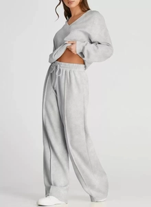Detail view of light grey loungewear set featuring V-neck sweatshirt and wide leg pants