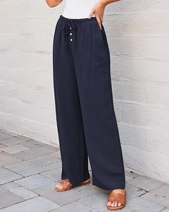Detail of high waist navy wide leg trousers featuring white button and drawstring waist