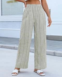 Detail showing elastic high waistband and vertical green stripes on linen-texture pants