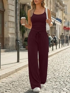 Close-up of wine red two-piece lounge set featuring spaghetti strap top and wide-leg pants