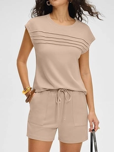 Detail of apricot summer set featuring pleated crewneck top and drawstring shorts with pockets