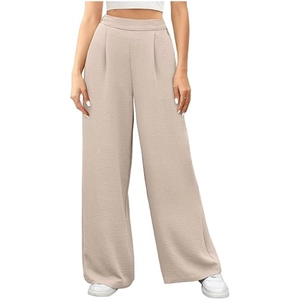 Detailed macro view of the textured vertical pleats and high-waisted beige fabric texture