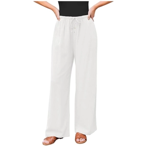Detail of white wide-leg linen pants featuring elastic drawstring waist and button accents